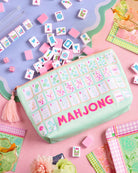 a soft nylon mahjong zipper bag with a pastel tile print, pink tassel pull, smooth top closure, and interior zipper pocket