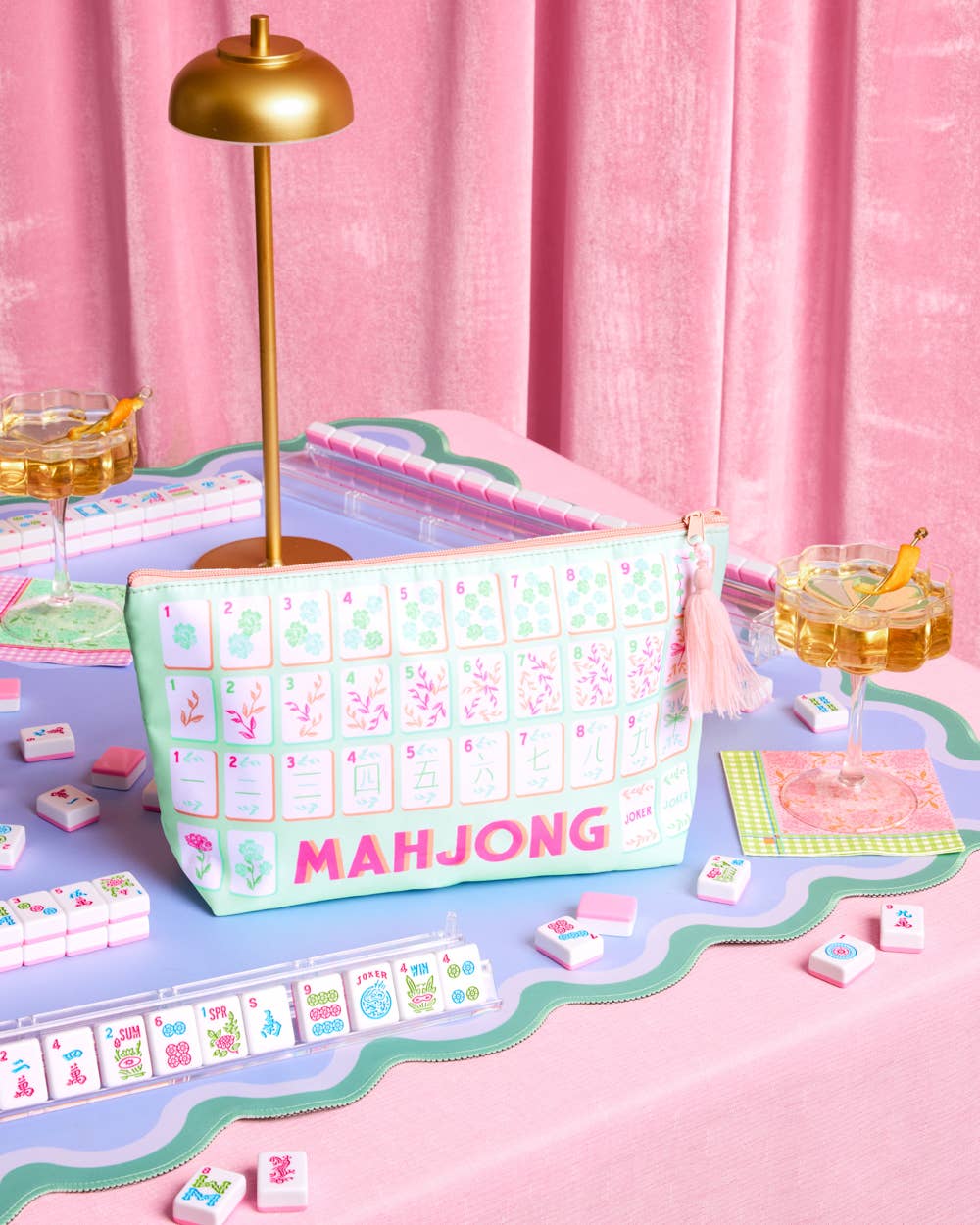 a soft nylon mahjong zipper bag with a pastel tile print, pink tassel pull, smooth top closure, and interior zipper pocket