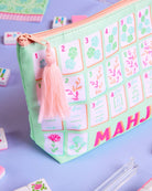 a soft nylon mahjong zipper bag with a pastel tile print, pink tassel pull, smooth top closure, and interior zipper pocket