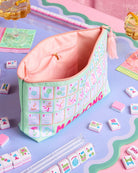 a soft nylon mahjong zipper bag with a pastel tile print, pink tassel pull, smooth top closure, and interior zipper pocket