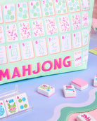 a soft nylon mahjong zipper bag with a pastel tile print, pink tassel pull, smooth top closure, and interior zipper pocket