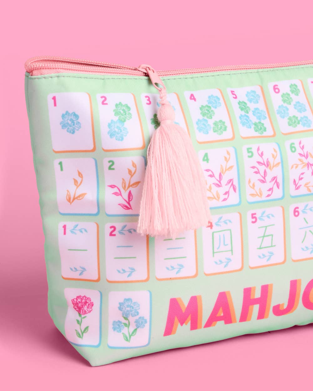 a soft nylon mahjong zipper bag with a pastel tile print, pink tassel pull, smooth top closure, and interior zipper pocket