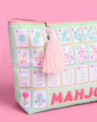 a soft nylon mahjong zipper bag with a pastel tile print, pink tassel pull, smooth top closure, and interior zipper pocket