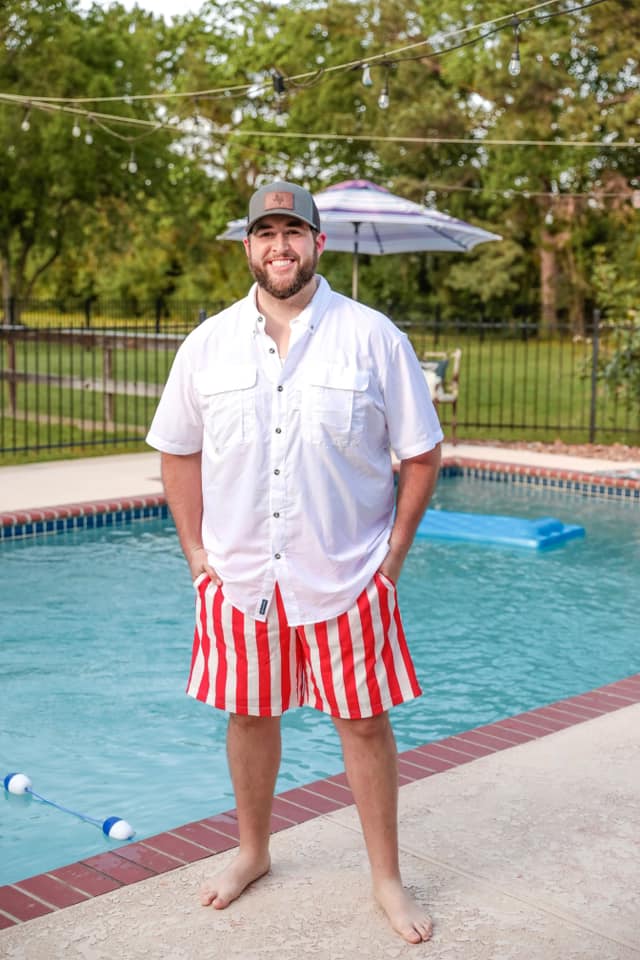 red and white vertical stripe swim trunks with an elastic waistband, drawstring tie, pockets, and built-in mesh underwear