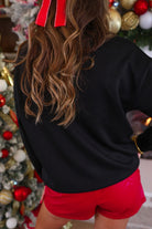 black long-sleeve sweatshirt with stitched chenille patches that spell out MERRY BRIGHT with an ampersand in between in alternating green, pink, and red on our new luxe material