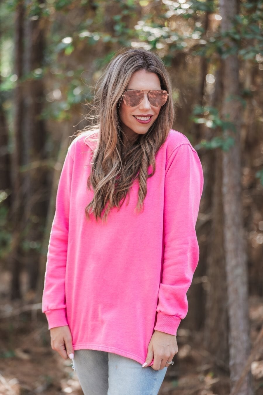 long sleeve pullover crafted from vintage wash fabric with a foldable collar, side slits, and a quarter zip in pink
