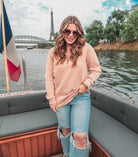 long sleeve pullover crafted from vintage wash fabric with a foldable collar, side slits, and a quarter zip in tan