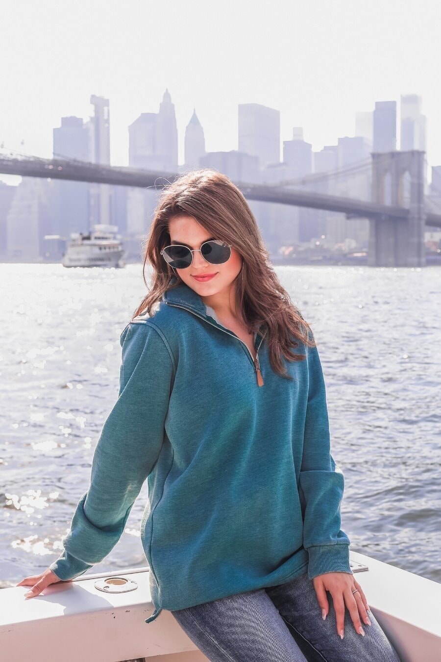 long sleeve pullover crafted from vintage wash fabric with a foldable collar, side slits, and a quarter zip in teal