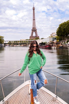 long sleeve pullover crafted from vintage wash fabric with a foldable collar, side slits, and a quarter zip in green