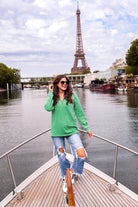 long sleeve pullover crafted from vintage wash fabric with a foldable collar, side slits, and a quarter zip in green