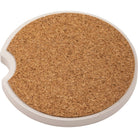 Round cork coaster with a white rim on a white background