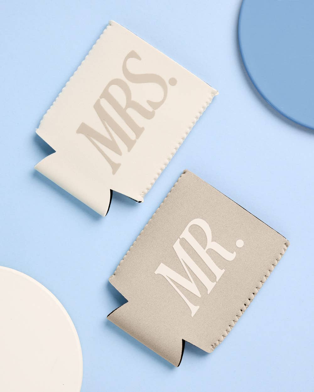 Two can coolers, one labeled 'Mrs.' and the other 'Mr.', on a light blue background.