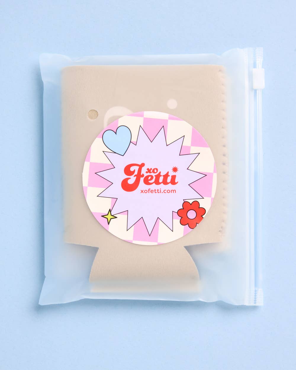 Product packaging with a decorative label on a light blue background