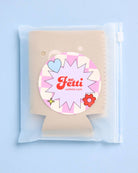 Product packaging with a decorative label on a light blue background