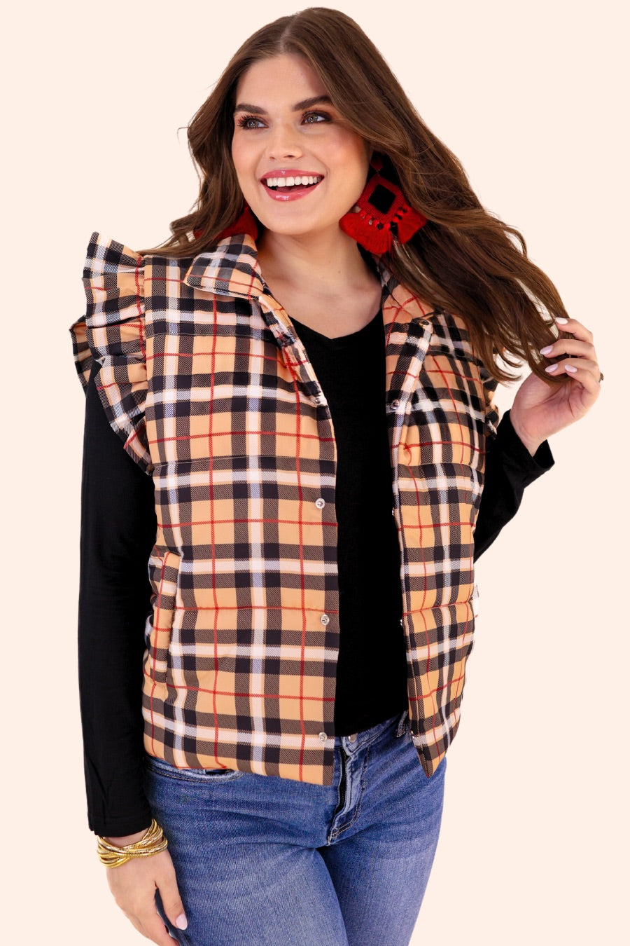 puffer vest with a collared neckline, short flutter sleeves, a button-up front, and hidden pockets on a fully lined quilted fabric in a black, red, taupe, and white plaid pattern