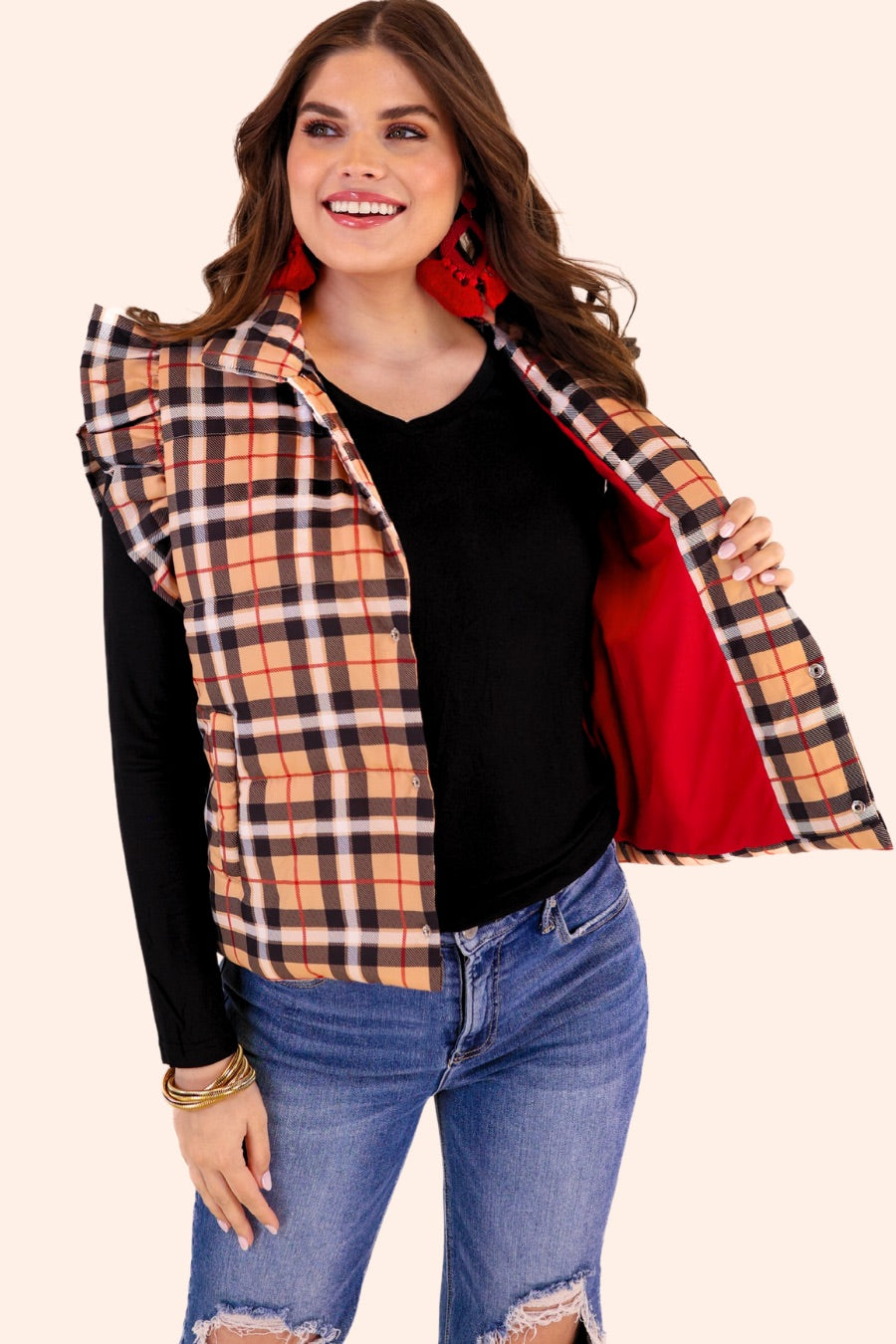 puffer vest with a collared neckline, short flutter sleeves, a button-up front, and hidden pockets on a fully lined quilted fabric in a black, red, taupe, and white plaid pattern