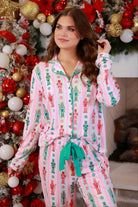 a soft two-piece pajama set (long sleeves and pants) with alternating nutcracker, peppermint, and aqua-and-pink stripe patterns, sweet ruffle hem detail, coordinating aqua trim accents, a decorative aqua faux belt, and a comfy elastic waistband for an easy, relaxed fit