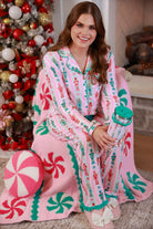 a soft two-piece pajama set (long sleeves and pants) with alternating nutcracker, peppermint, and aqua-and-pink stripe patterns, sweet ruffle hem detail, coordinating aqua trim accents, a decorative aqua faux belt, and a comfy elastic waistband for an easy, relaxed fit