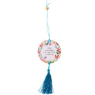 Decorative hanging tag with floral design and tassel on a white background