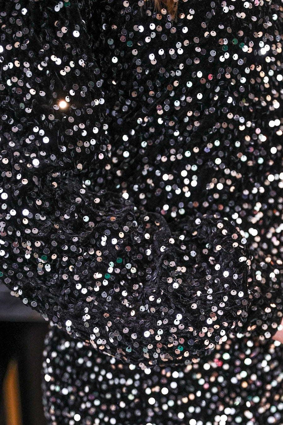 a black long balloon sleeve dress made of sparkly allover sequins, luxe velvet underlay, a keyhole accented upper back with button closure, a round neckline, and subtle elastic cuffs