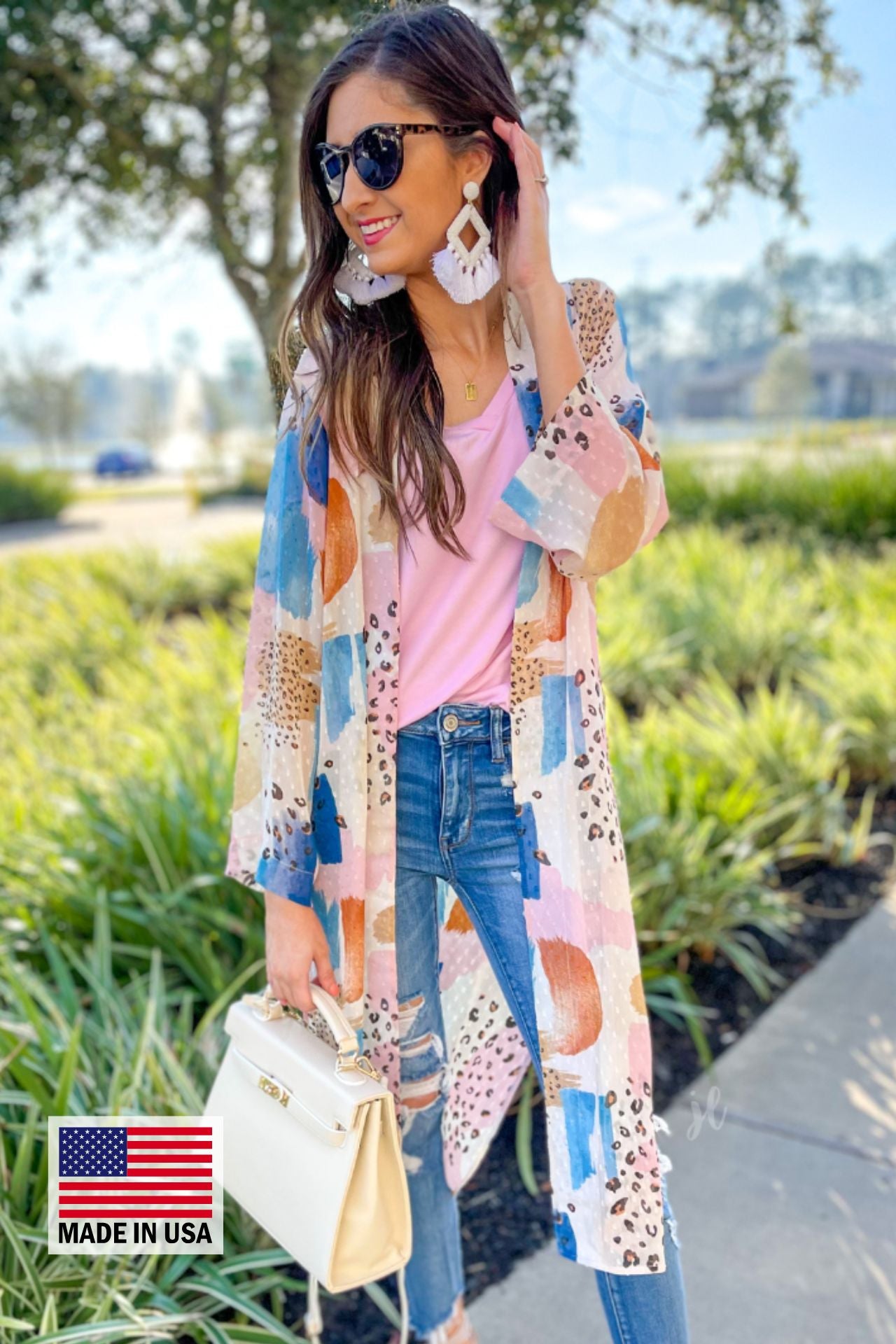 open front kimono made from flowy, lightweight fabric adorned with a striking mix of stripes and animal print motifs in ivory