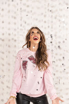 pink long sleeve top with shimmering silver rhinestones, sequins, & pearls champagne toasting glasses