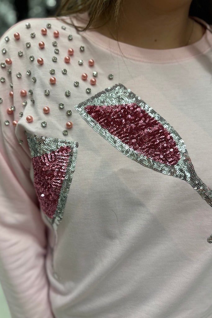 pink long sleeve top with shimmering silver rhinestones, sequins, & pearls champagne toasting glasses