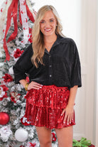 a plush velvet button-up top with subtle metallic threading, a relaxed flattering fit, three-quarter sleeves, and a soft drape for easy elegance in black