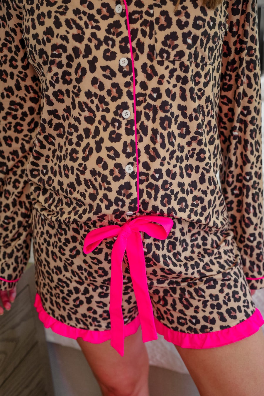 long sleeve top and matching shorts on a brown leopard fabric with hot pink accents