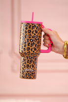 40-ounce tumbler with a hot pink and leopard print design, handle, screw-on lid, and a reusable straw