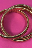 three intertwined stretch bands with a slip-on design in gold