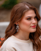 gold-plated post-back skeleton-shaped dangle earrings with rhinestone accents, skull stud tops, articulated bone design, matching barrel backs, and nickel/lead compliant construction in silver
