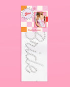 Silver 'Bride to Be' sash on a pink background with packaging