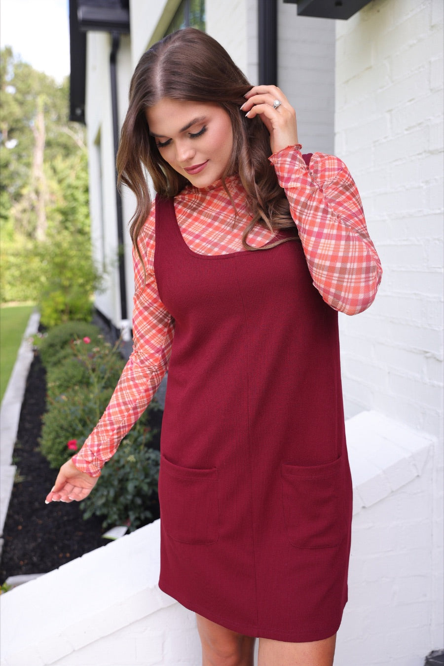 sleeveless ribbed dress with a scoop neckline, front patch pockets, and a relaxed silhouette in burgundy