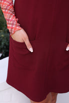 sleeveless ribbed dress with a scoop neckline, front patch pockets, and a relaxed silhouette in burgundy