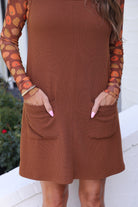 sleeveless ribbed dress with a scoop neckline, front patch pockets, and a relaxed silhouette in chocolate