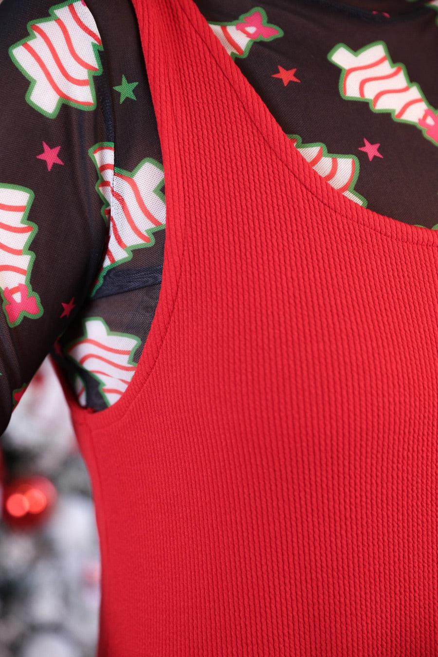 sleeveless ribbed dress with a scoop neckline, front patch pockets, and a relaxed silhouette in red