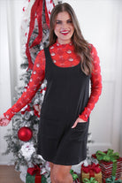 sleeveless ribbed dress with a scoop neckline, front patch pockets, and a relaxed silhouette in black