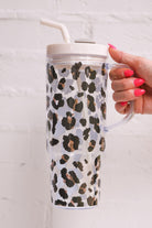 40-ounce black and brown animal print acrylic tumbler with a reusable straw (ivory), flexible mouthpiece (ivory), handle, screw-on lid (ivory with a grey rotate lid tab), and car cup holder compatible