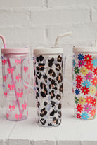 40-ounce pink bows, animal. print, and flowers pattern acrylic tumblers with a reusable clear straw, flexible mouthpiece, handle, screw-on lid, and car cup holder compatible