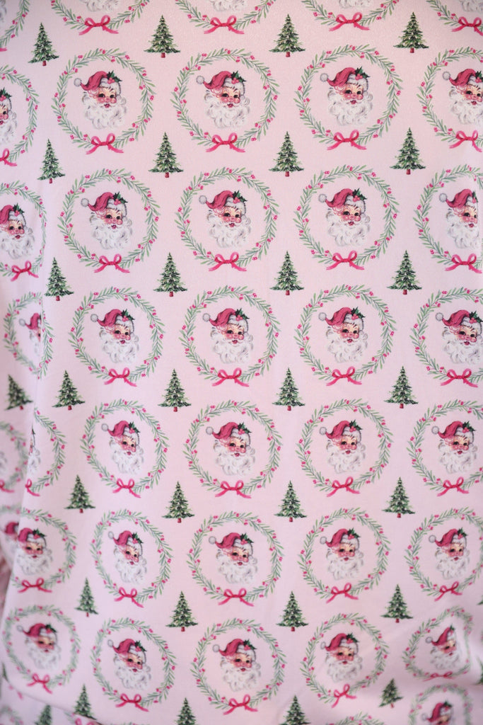 long sleeve top and matching shorts on a custom-designed solid light pink fabric with a vintage Santa pattern and Christmas tree