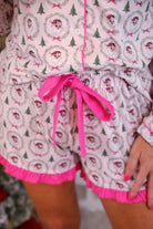 long sleeve top and matching shorts on a custom-designed solid light pink fabric with a vintage Santa pattern and Christmas tree