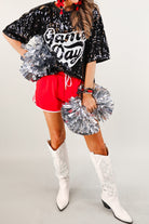 a full sequin design on a solid color with the words GAME DAY on the center front outlined in white sequins, a boxy fit, and a lined interior