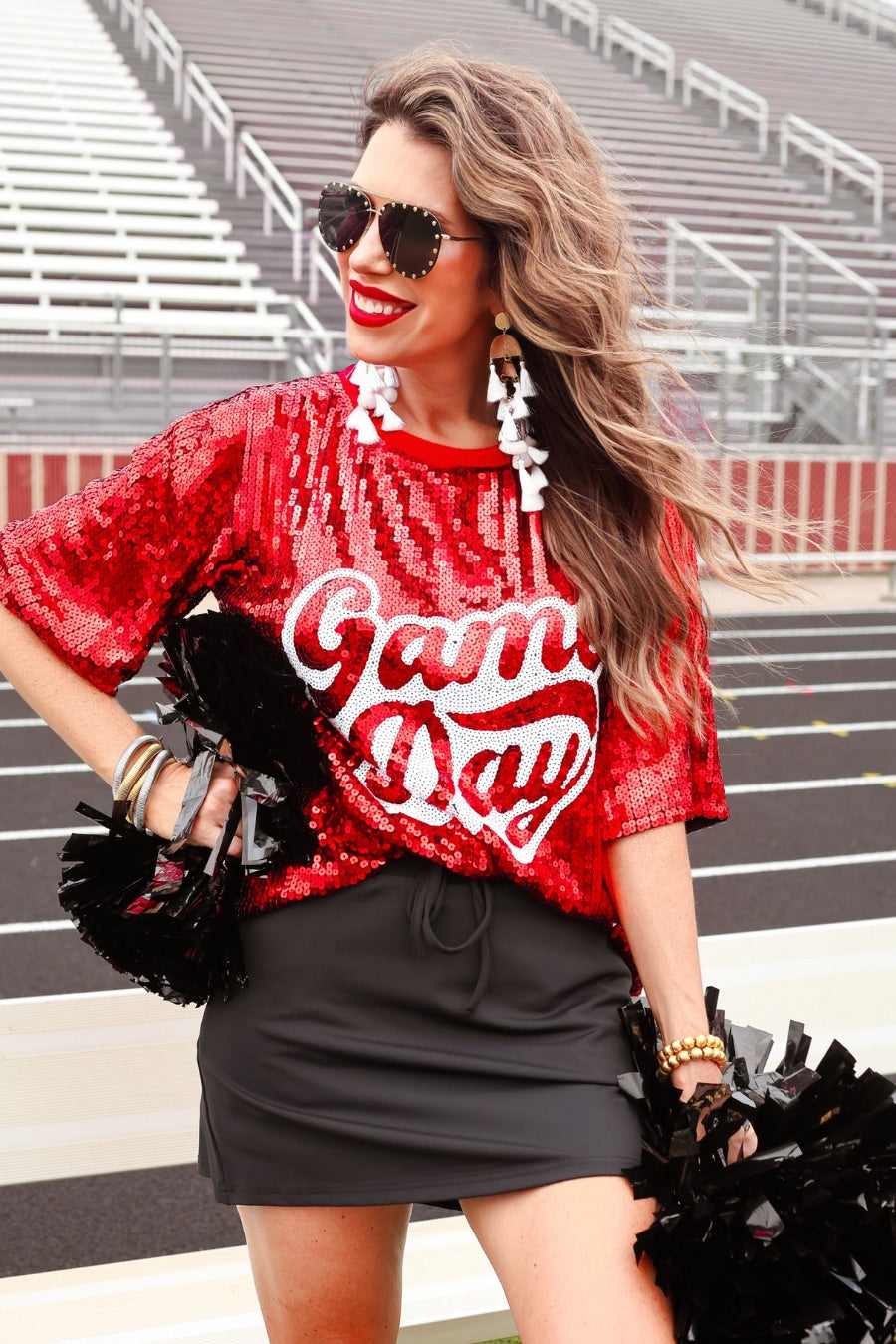 a full sequin design on a solid color with the words GAME DAY on the center front outlined in white sequins, a boxy fit, and a lined interior