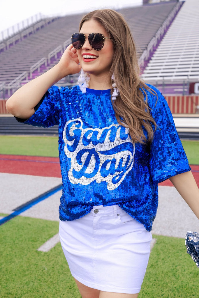 a full sequin design on a solid color with the words GAME DAY on the center front outlined in white sequins, a boxy fit, and a lined interior