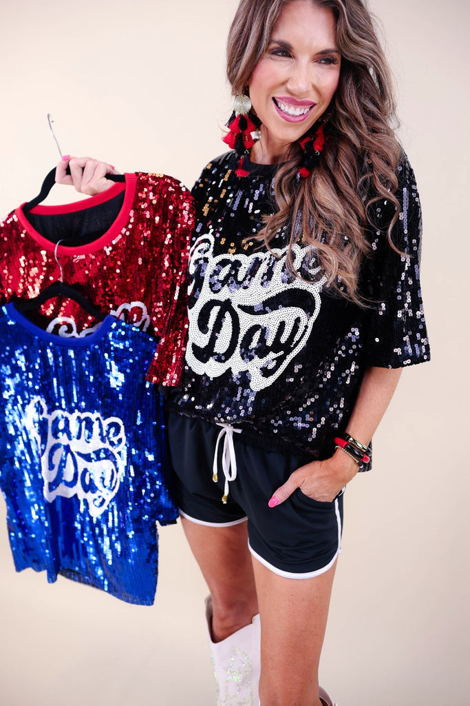 a full sequin design on a solid color with the words GAME DAY on the center front outlined in white sequins, a boxy fit, and a lined interior