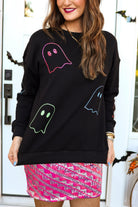 a black long-sleeve pullover crafted from soft fabric with a crew neckline, dropped shoulders, ribbed cuffs, banded hem, relaxed fit, classic sweatshirt silhouette, and colorful sequin ghost outline pattern across the front, back, and sleeve