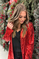 long sleeve blazer with all-over sequins, a collar, & an interior lining