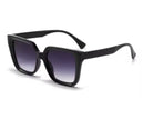 oversized square sunglasses in black with dark lenses, a raised geometric texture on the temples, and brand name detail (on both the temple and the complimentary black pouch)