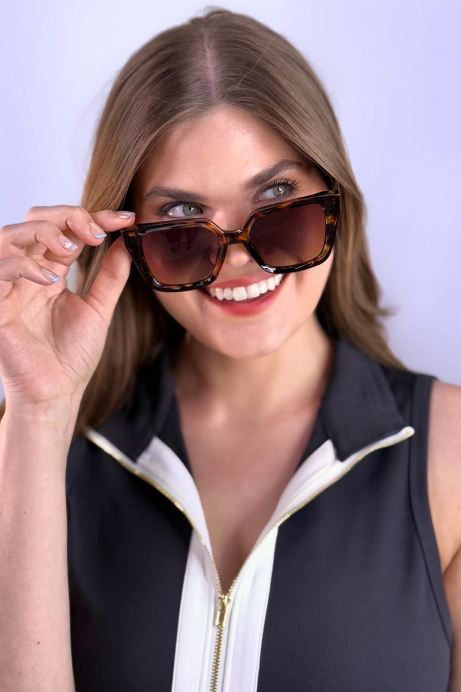 oversized square sunglasses in  tortoise with dark lenses, a raised geometric texture on the temples, and brand name detail (on both the temple and the complimentary black pouch)
